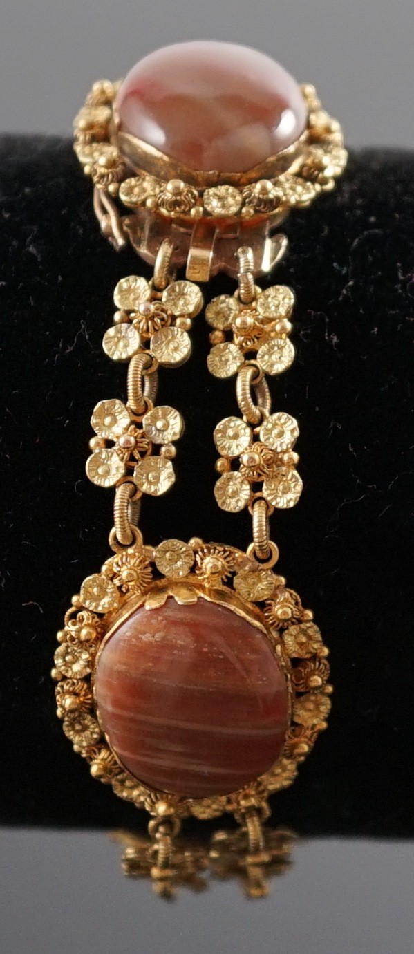 An early 19th century gold and four stone oval cabochon hardstone set bracelet